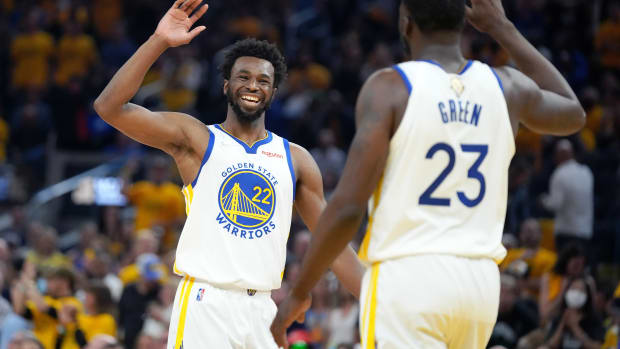Jun 13, 2022; San Francisco, California, USA; Golden State Warriors forward Andrew Wiggins (22) and forward Draymond Green (23) celebrate during the first half in game five of the 2022 NBA Finals against the Boston Celtics at Chase Center. Mandatory Credit: Kyle Terada-USA TODAY Sports